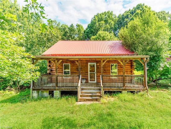Charming rustic log cabin with covered porch listed by Rob Herald Realty in rural North Carolina