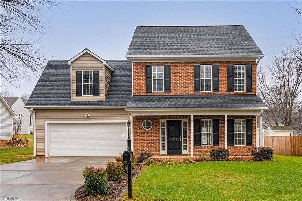 Traditional brick colonial home with black shutters sold by Rob Herald in the NC Triad area